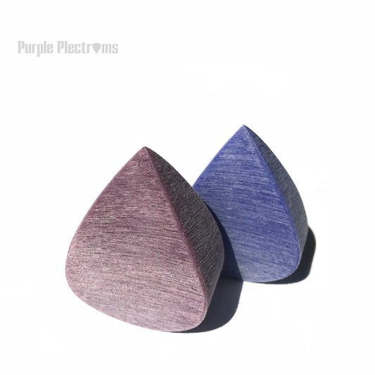 two very big picks standing back to back against a white background