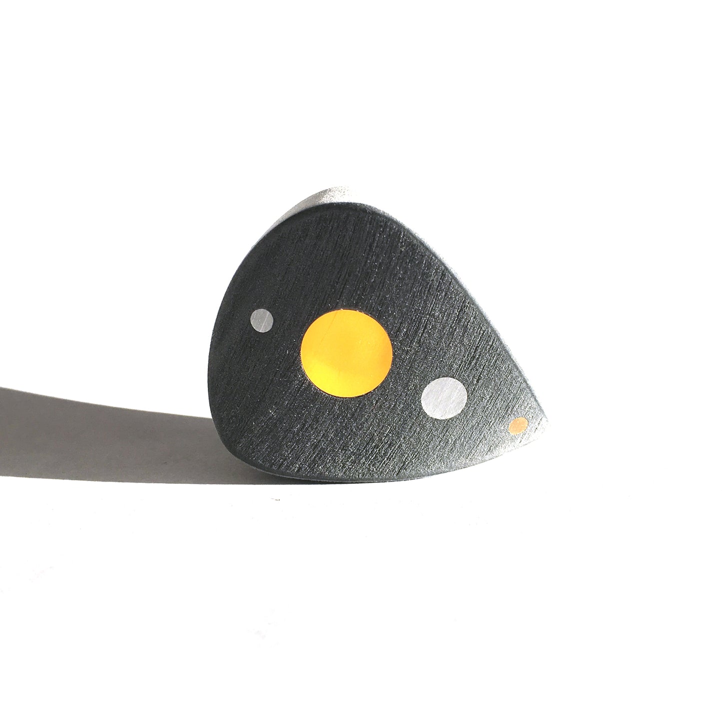 grey thick guitar pick with color optics along the spine