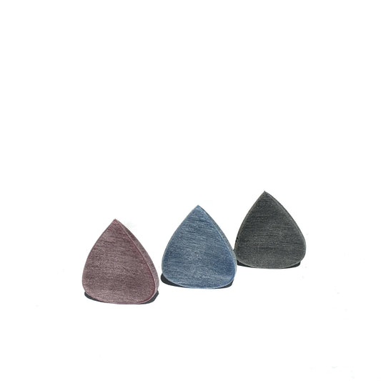 trio of guitar picks against a white background