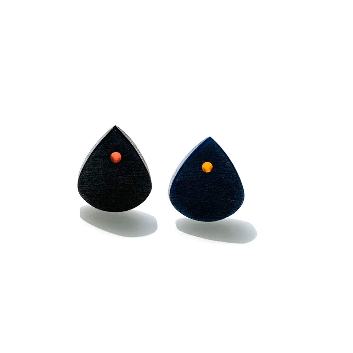 pair of small guitar picks with a single color optic
