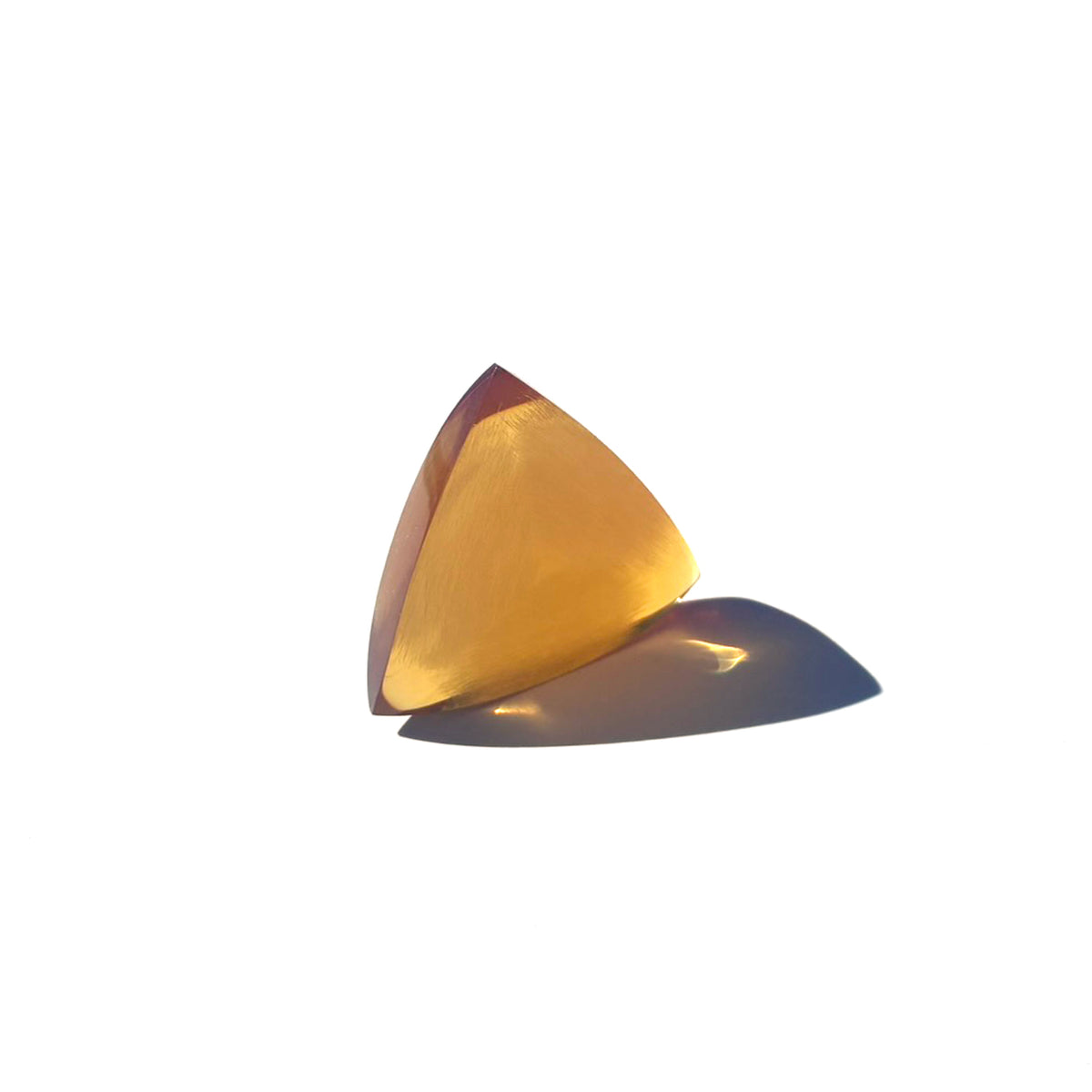 Handcrafted 6mm Mythos triangular guitar pick made from amber Ultem thermoplastic with a diamond-faceted brushed texture and three sharp bevels.