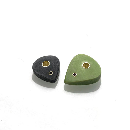 pair of picks with brass inserts bathed in sun
