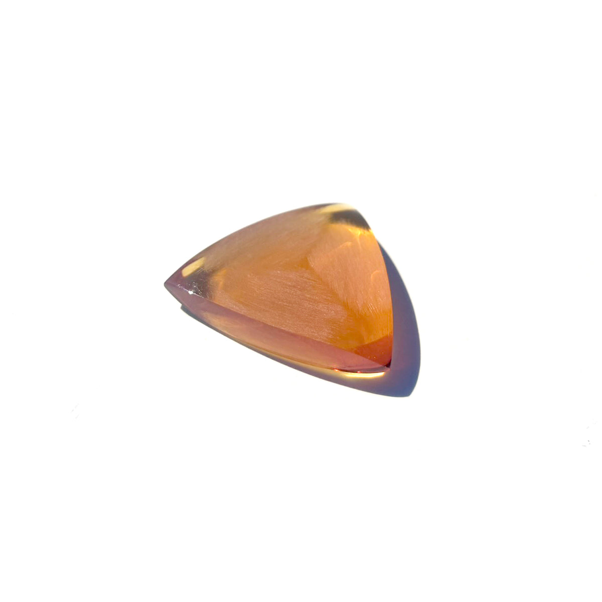 Handcrafted 6mm Mythos triangular guitar pick made from amber Ultem thermoplastic with a diamond-faceted brushed texture and three sharp bevels.