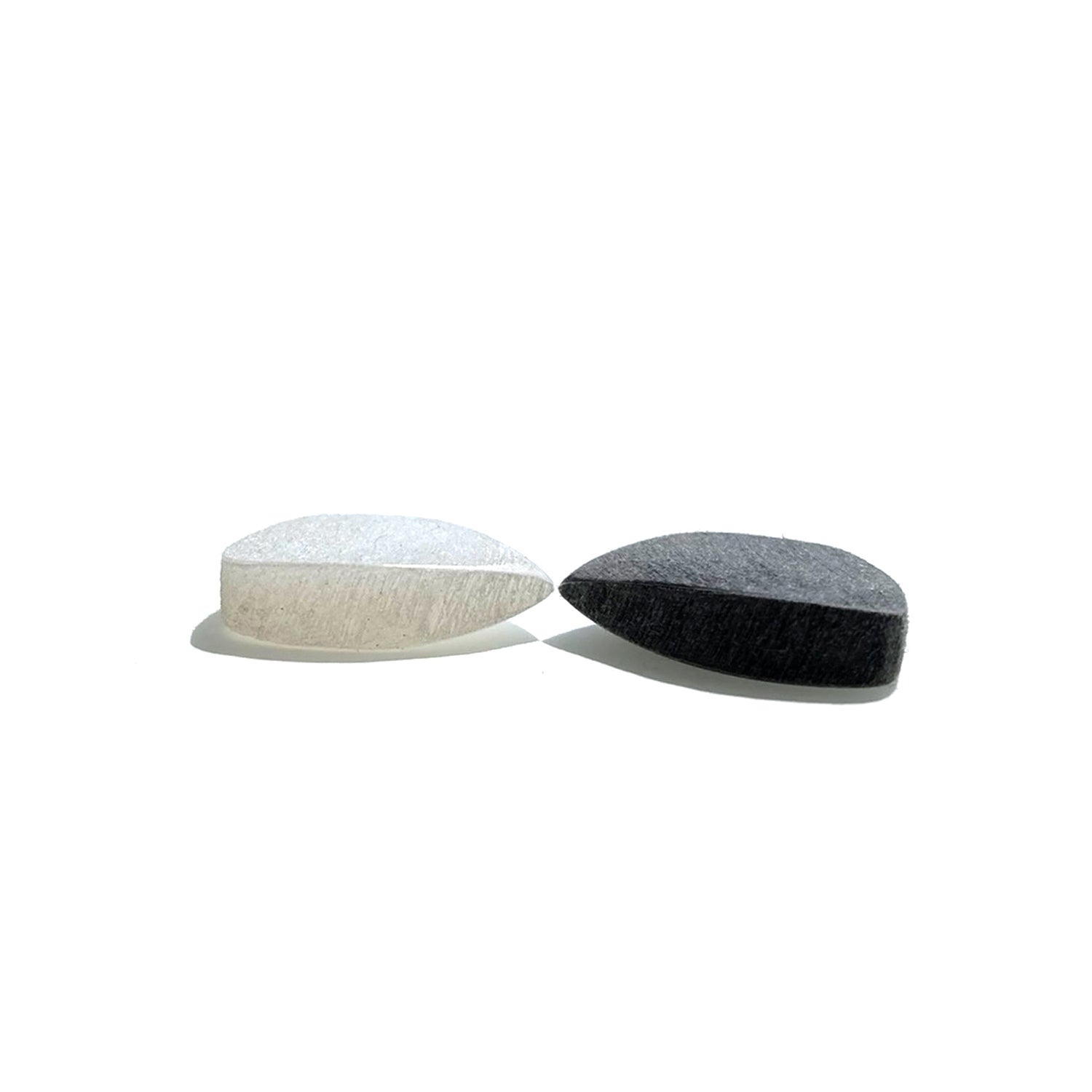 pair of black and white Amar guitar picks