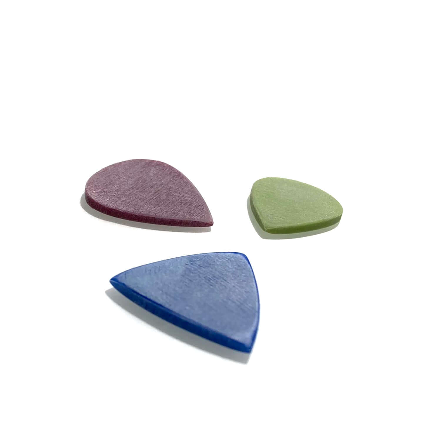 ThinLine guitar picks in purple, green, and blue colors on a white background.
