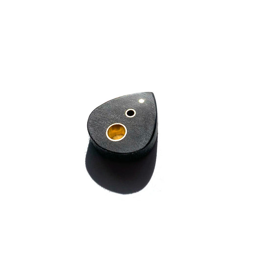 small black guitar pick with brass inserts