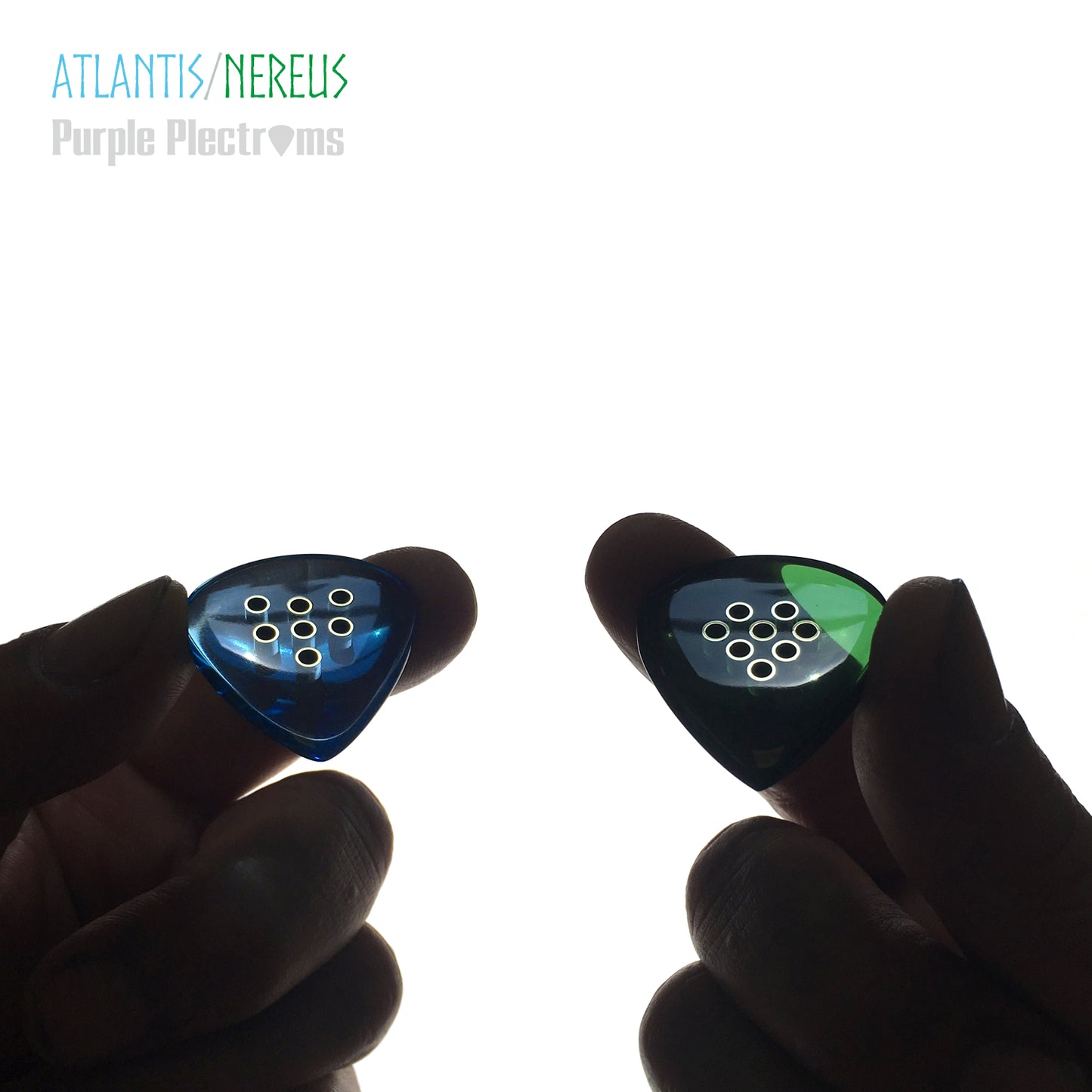 pair of green and blue guitar picks with brass inserts