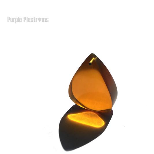 massive amber color guitar pick made from ultem 