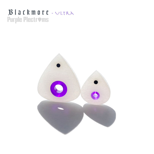pair of white and purple guitar picks bathed in sunlight