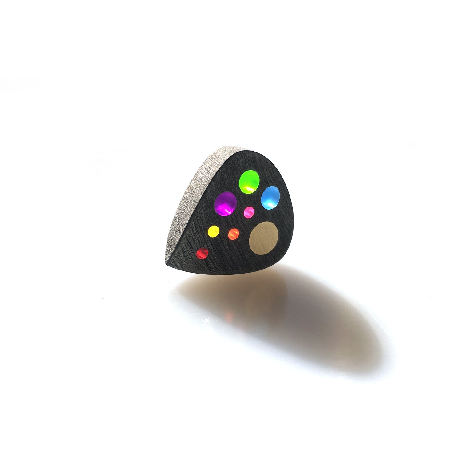 Guitar pick with many color optics designed to represent the solar system