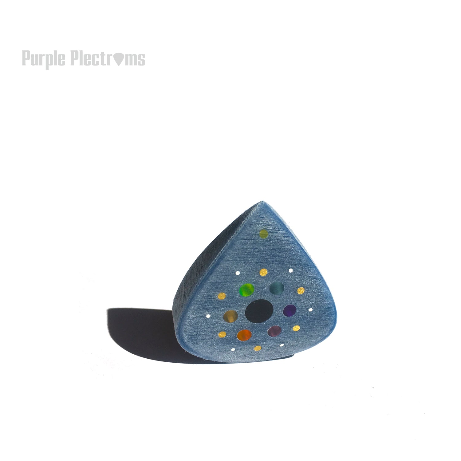 Guitar pick with many color optics designed to represent the solar system