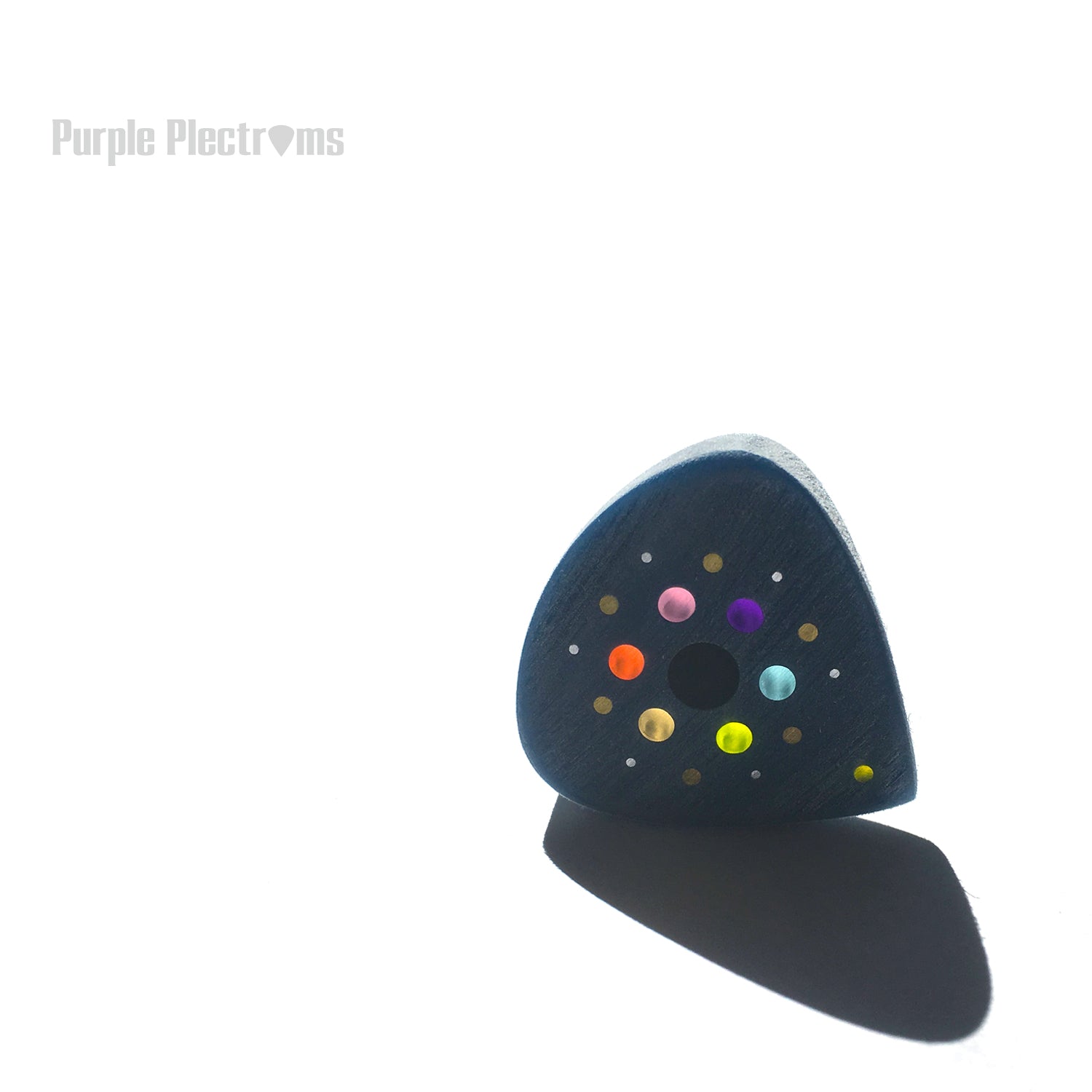 Guitar pick with many color optics designed to represent the solar system