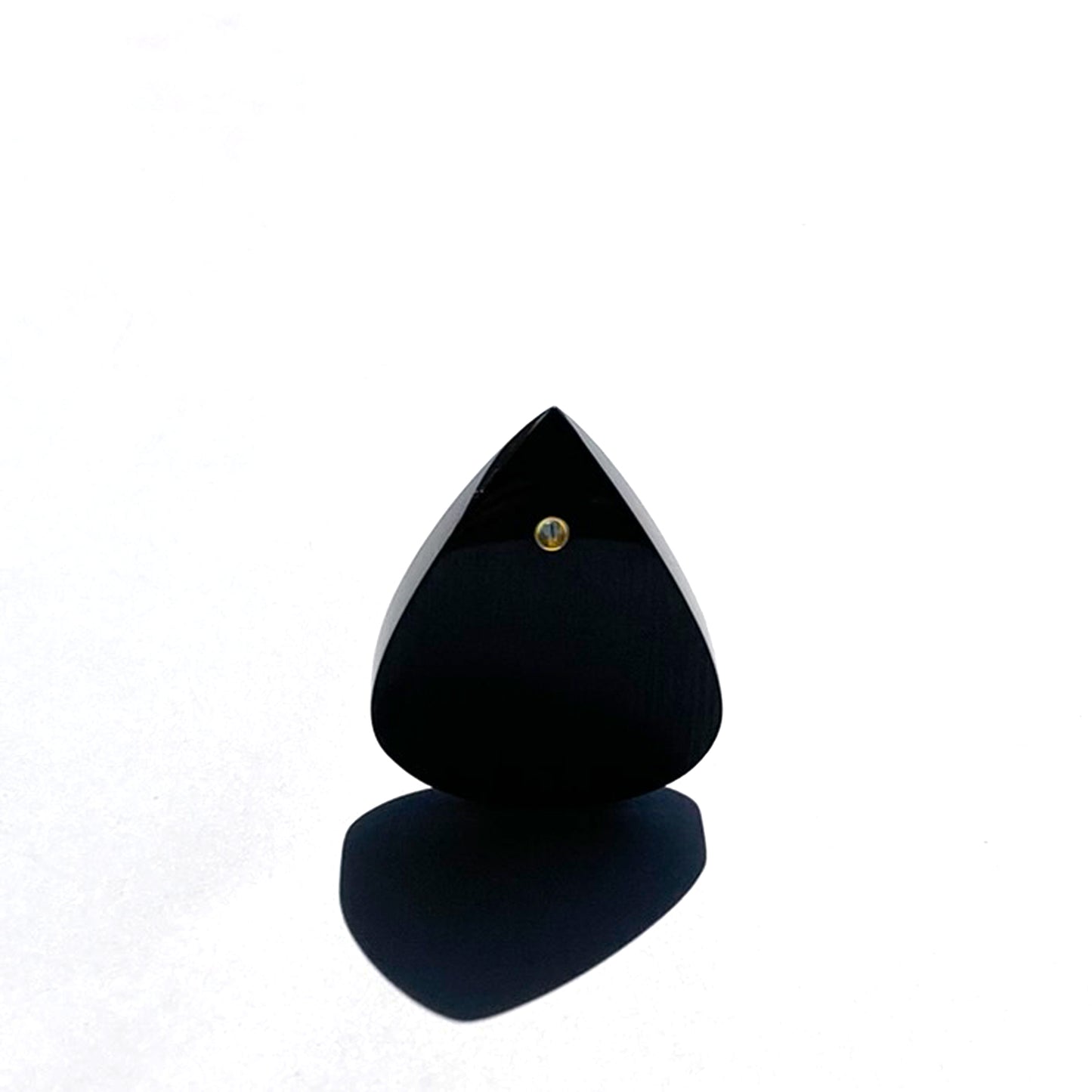 black guitar pick on a white background bathed in sunlight